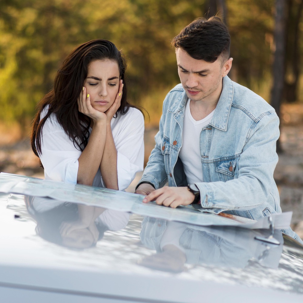front-view-couple-looking-map