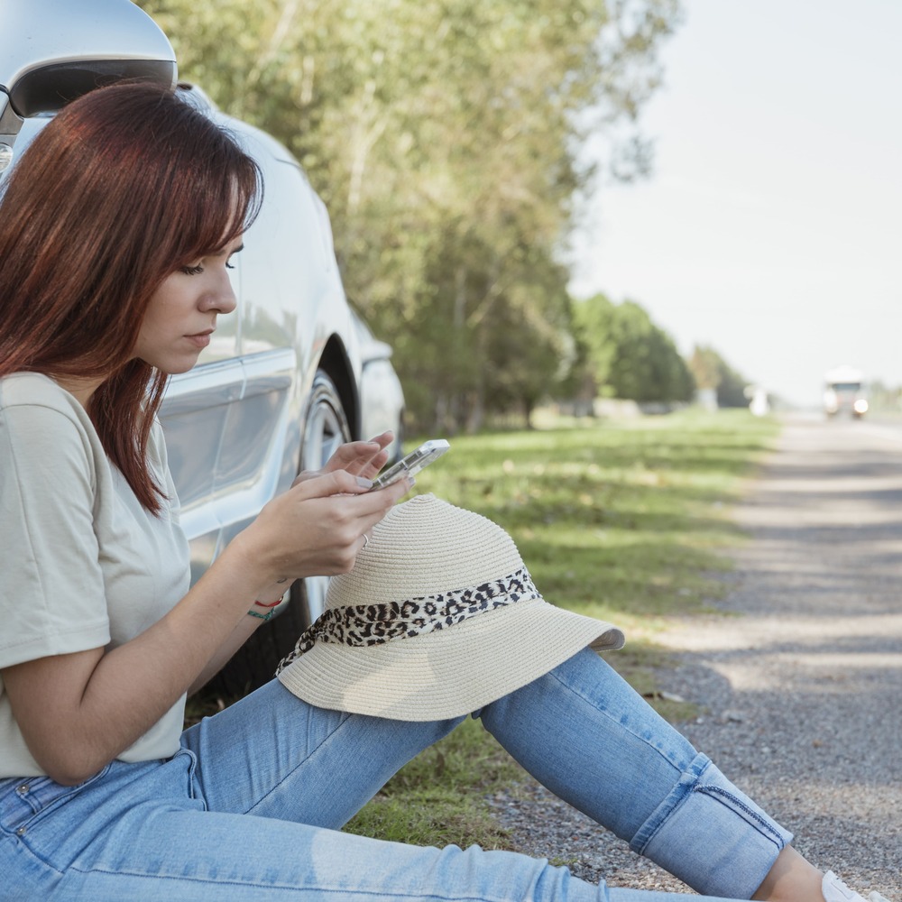 woman-with-smartphone-leaning-ag